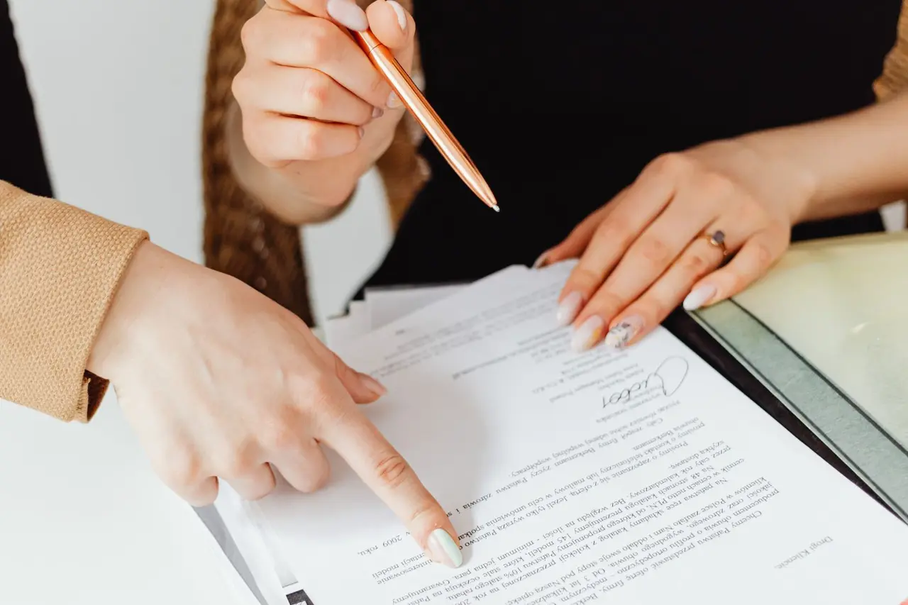 Two people reviewing business paperwork and project costs together