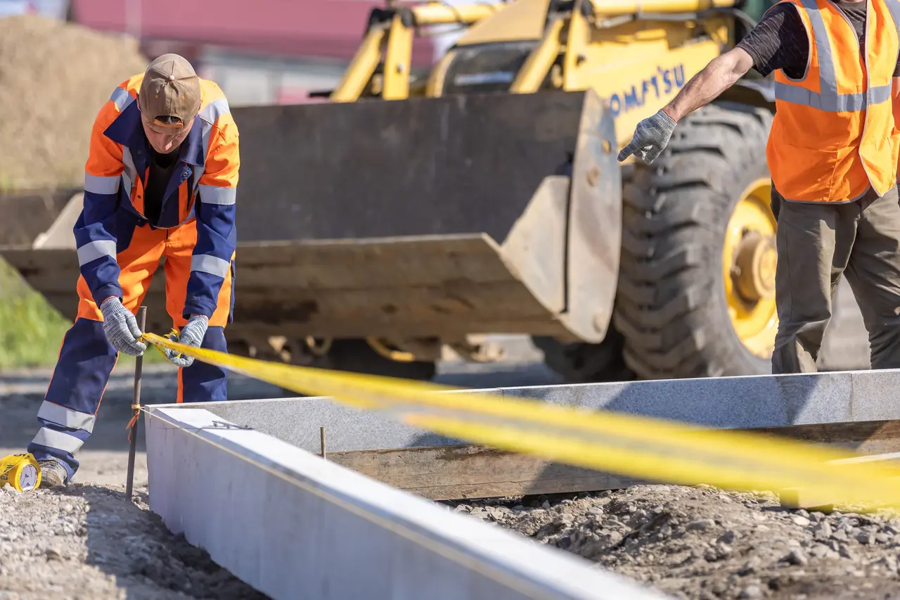 Construction crew measuring work on an active job site