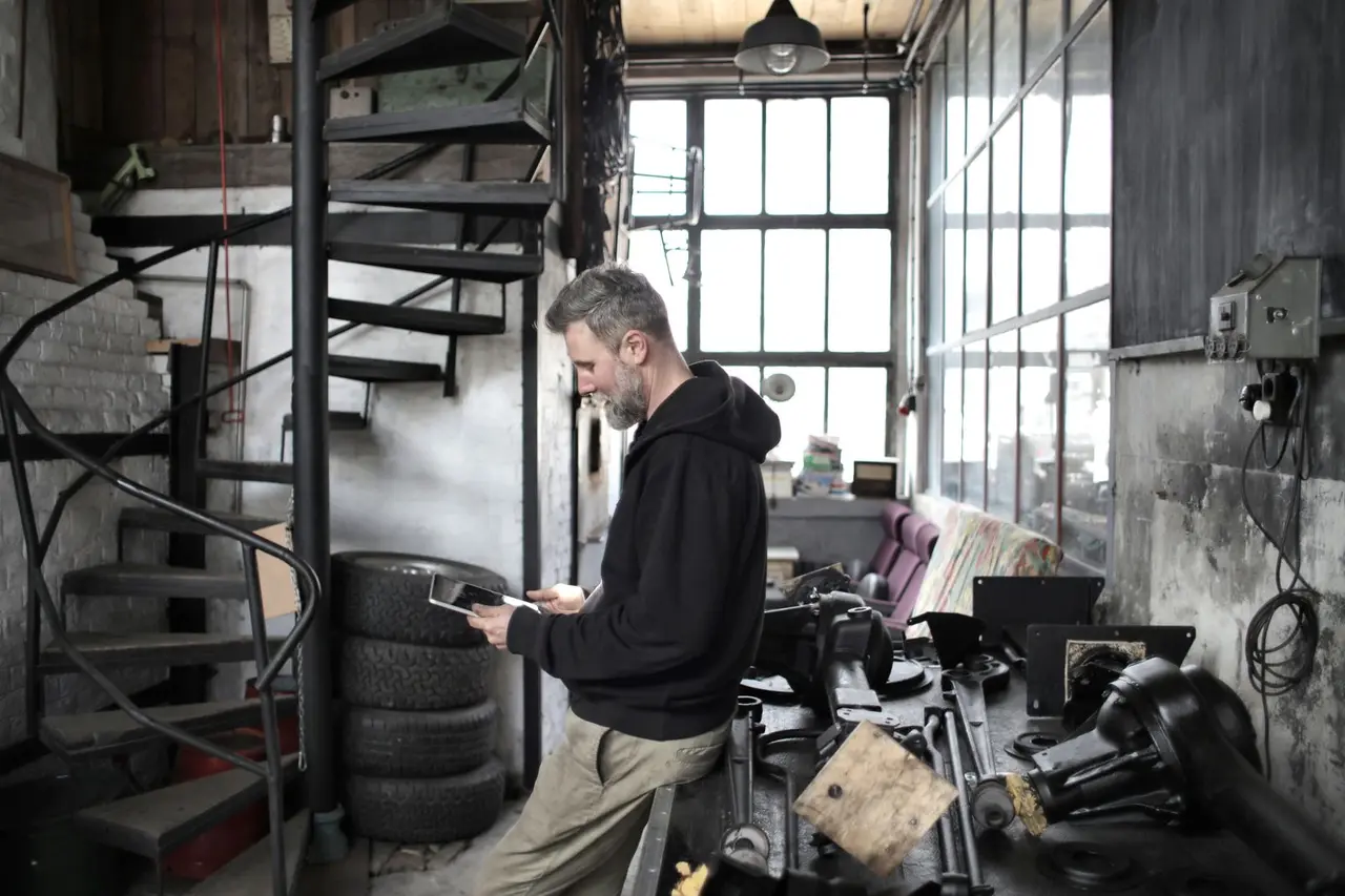 Service business owner using a tablet in a workshop