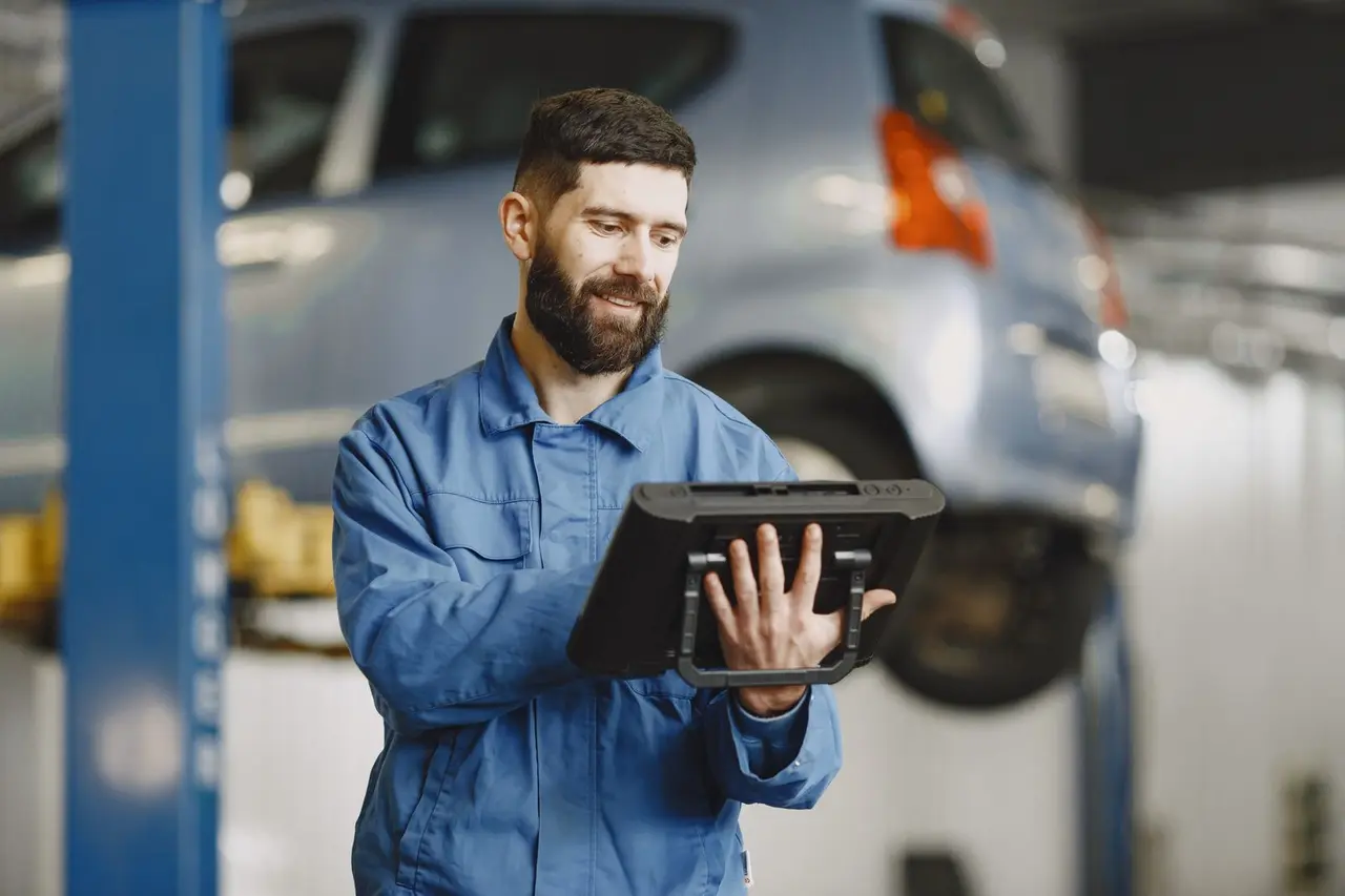 Solo service professional using a tablet in a repair shop